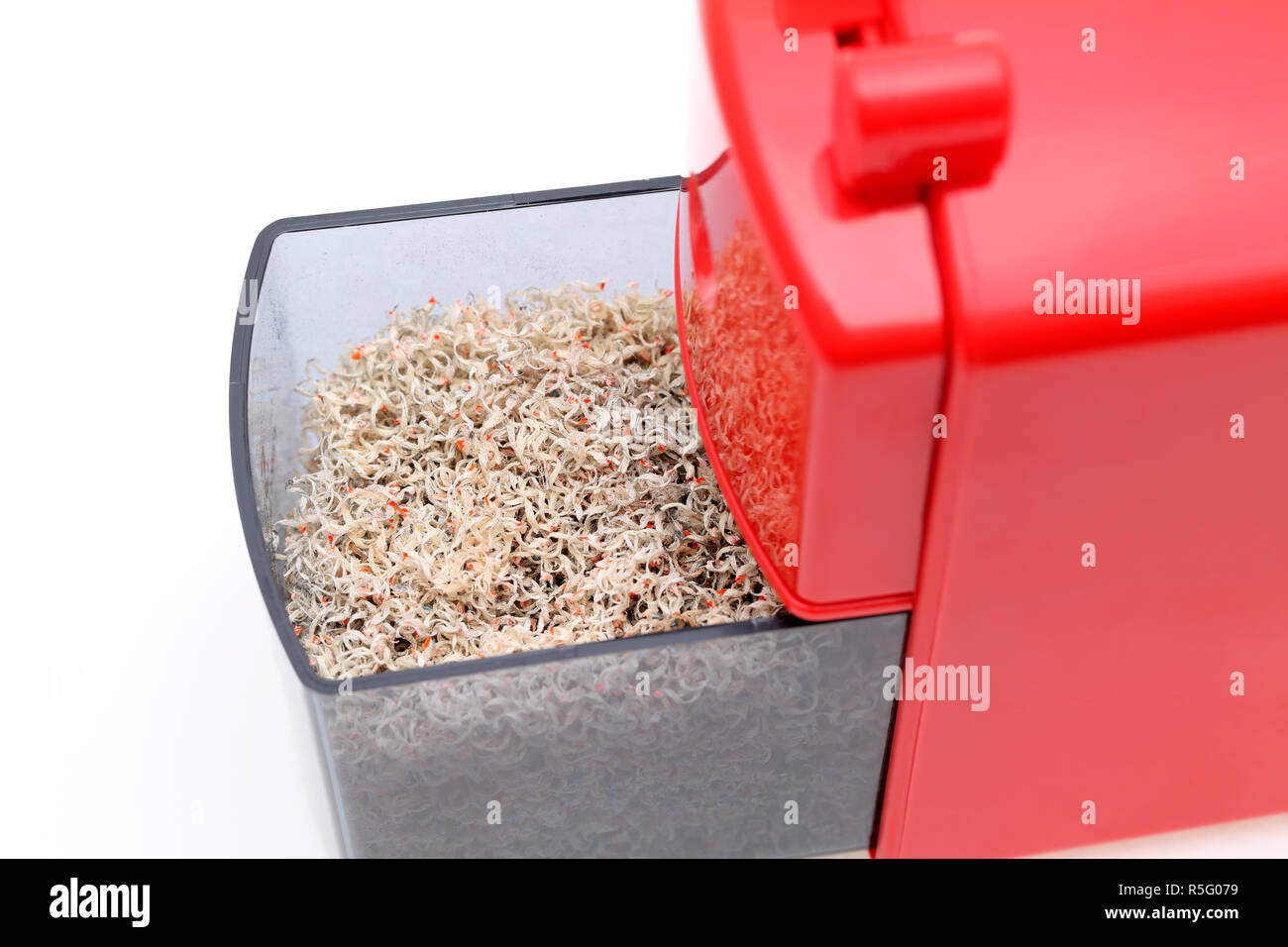 Red pencil sharpener with pencil trash on white background Stock Photo Alamy