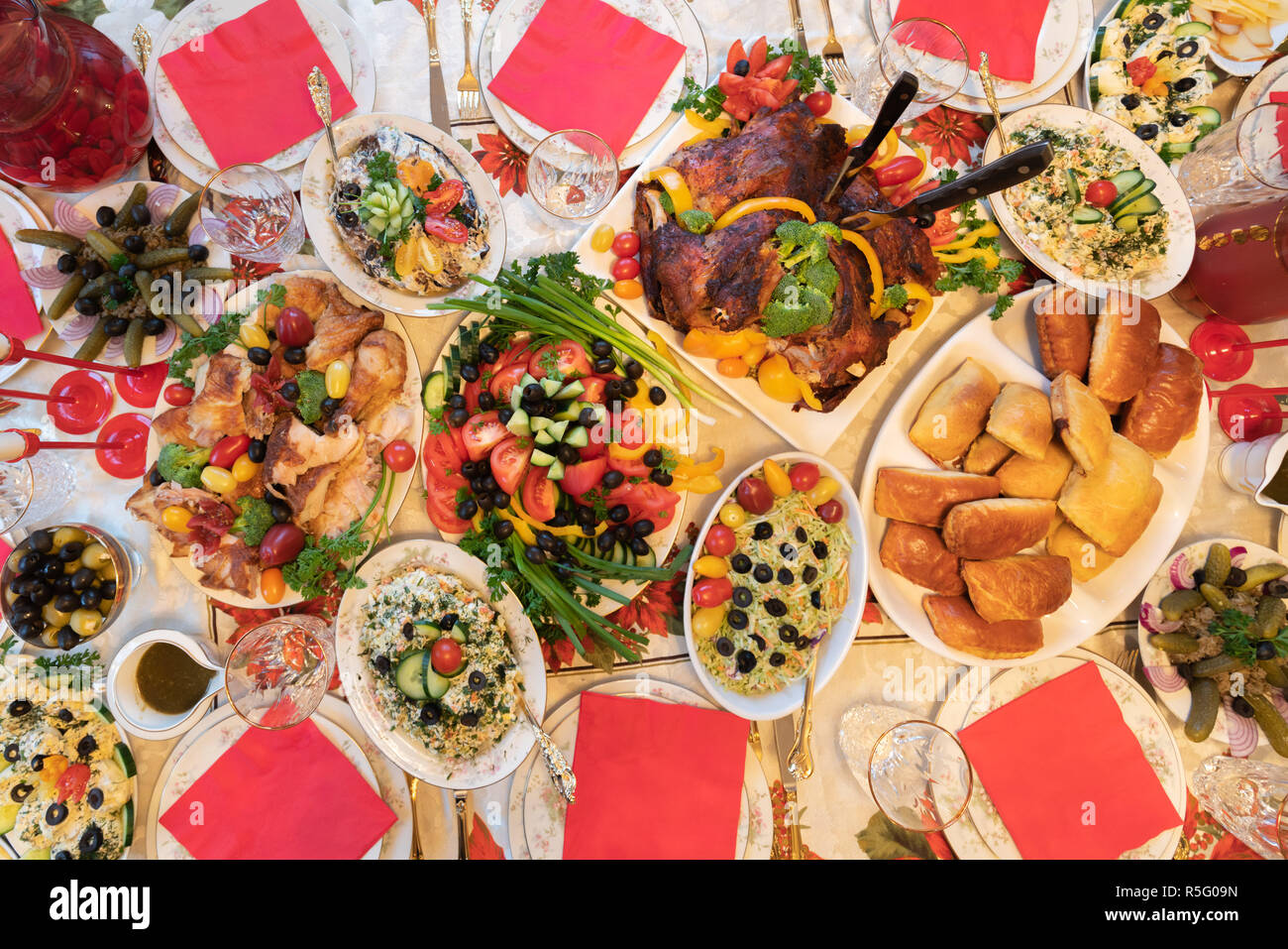 Thanksgiving traditional turkey dinner mixed with eastern European foods and dishes. View from above. Stock Photo