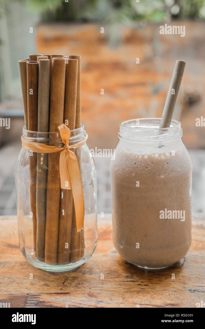 Milkshake with Bamboo straw. Milchshake vor hellem Hintergrund mit Bambus Strohhalm Stock Photo