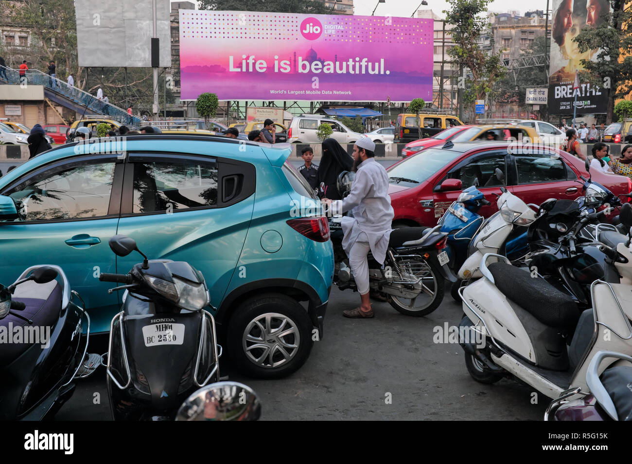 A road view of congested Marine Drive in Mumbai, India, under an advertisement of mobile phone service provider Jio, 'Life is Beautiful' Stock Photo