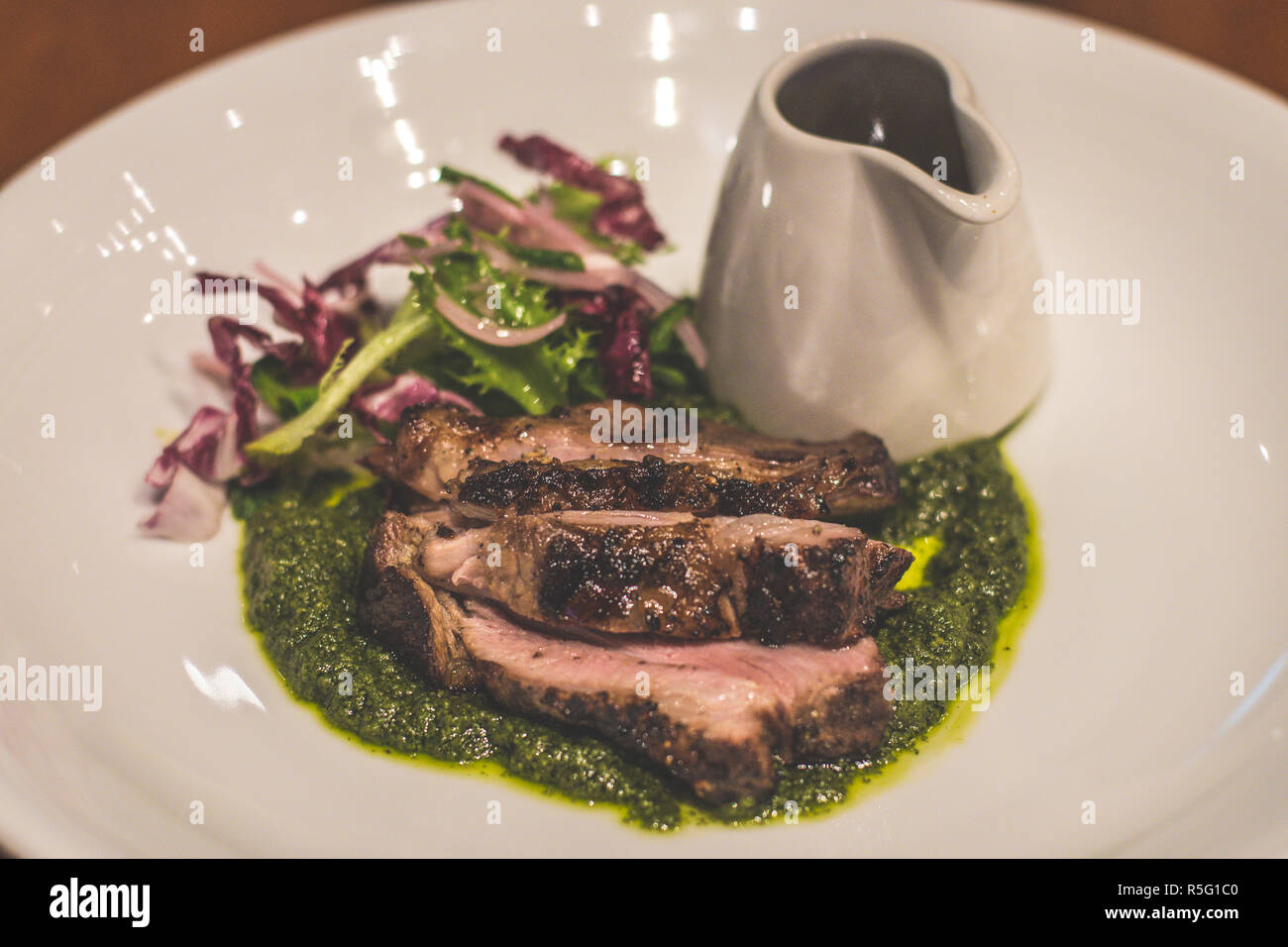 Lamb Leg Slow-roasted, rosemary, garlic, salsa verde Stock Photo