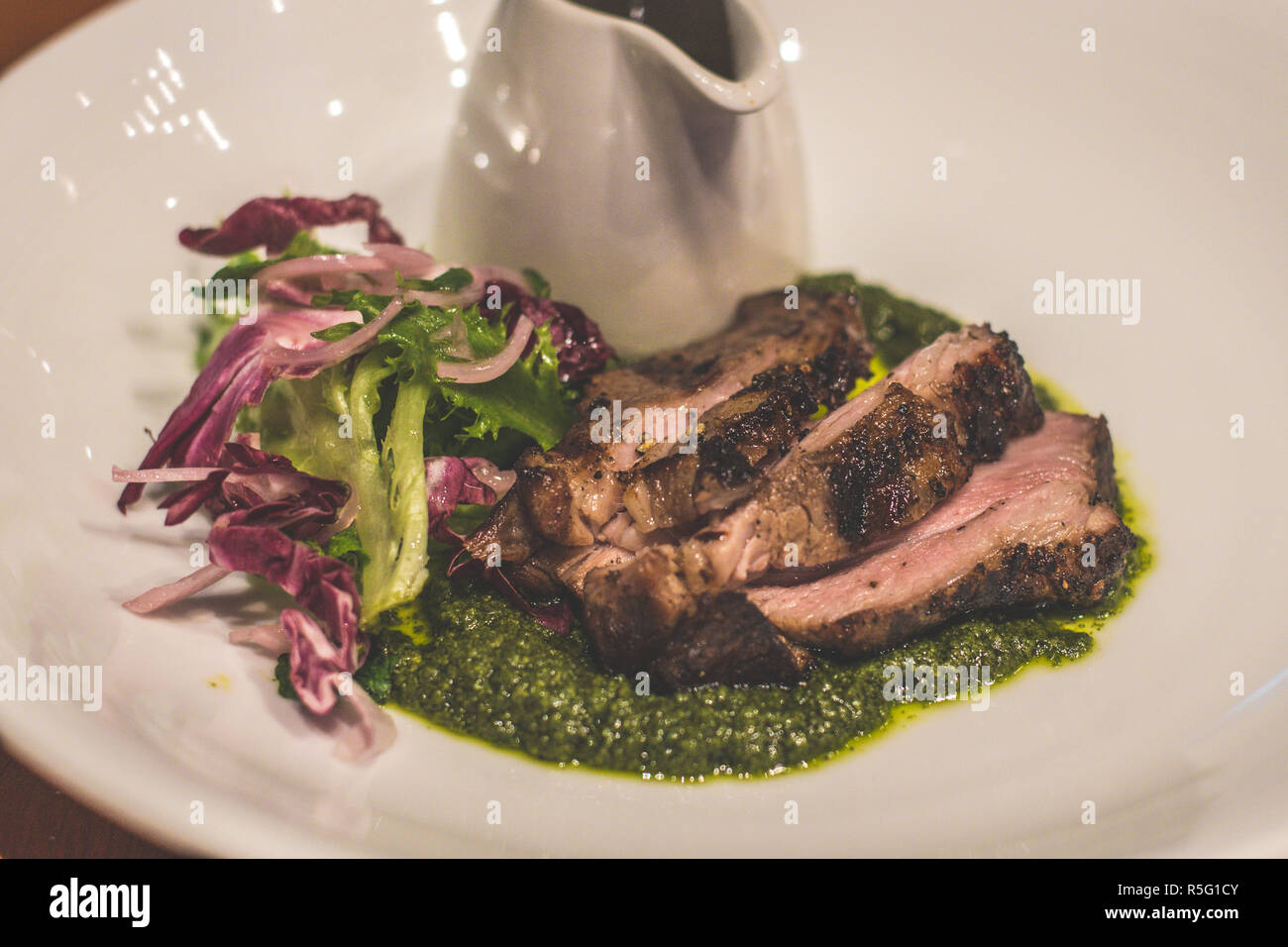 Lamb Leg Slow-roasted, rosemary, garlic, salsa verde Stock Photo