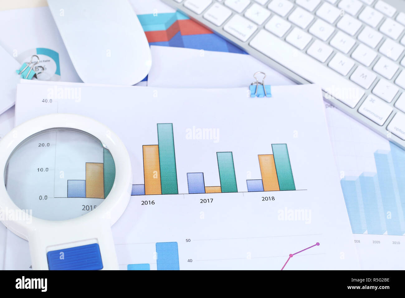 Chart paper, Magnifying glass, keyboard and mouse Stock Photo - Alamy