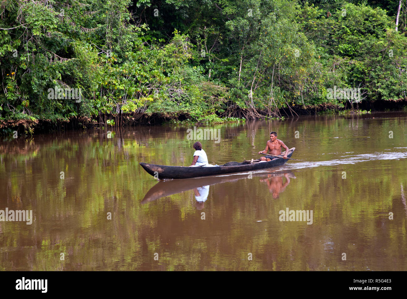 Venezuela, Delta Amacuro, Orinoco Delta, Warao People in dug out canoe on Nararina river Stock Photo