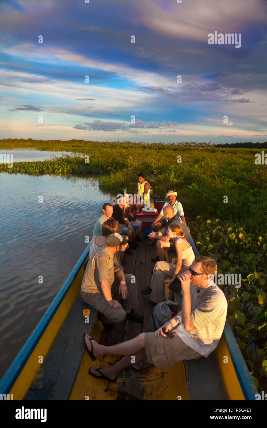 Venezuela, Delta Amacuro, Orinoco Delta, Tigre River, Tourists relaxing on boat Stock Photo