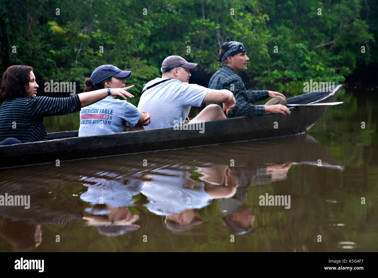 Venezuela, Delta Amacuro, Orinoco Delta,Tourists birdwatching in dug out canoe Stock Photo