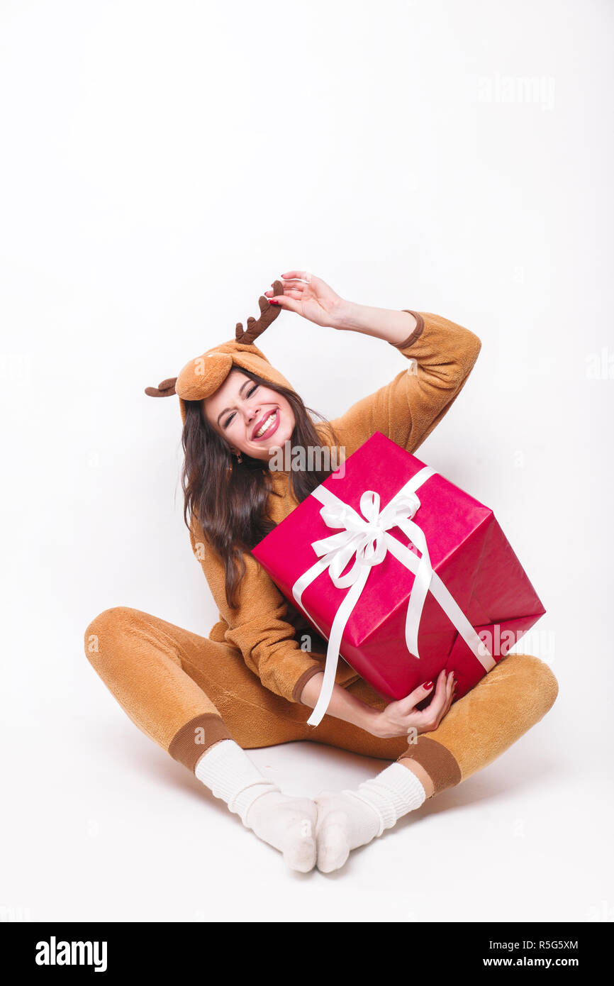 Kigurumi pajamas deer. Cute young woman in pajamas sitting with big red ...