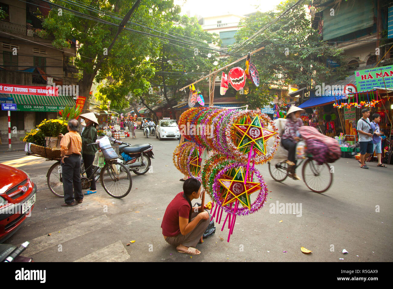 Woman selling decorations for the Mid Autumn moon festival, Old Quarter, Hanoi, Vietnam Stock Photo