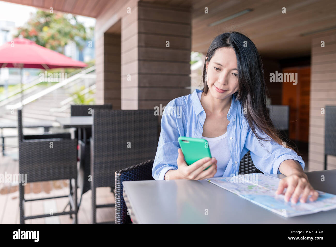Woman use of cellphone and city map in Hong Kong Stock Photo - Alamy