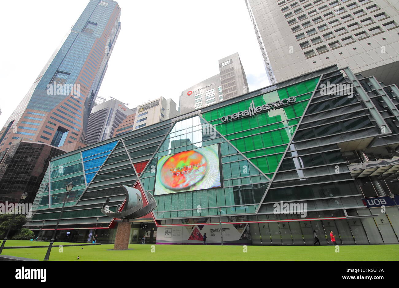 People visit One Raffles Place in Singapore. Stock Photo