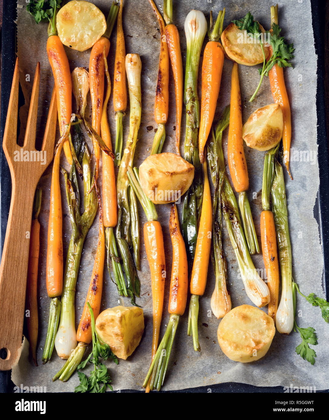 caramelised carrots,spring onions and baked potatoes Stock Photo Alamy