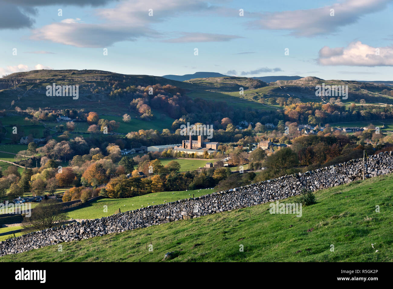 An Autumn view of Ribblesdale, North Yorkshire. with Langcliffe Mill in the valley bottom and Ingleborough peak on the horizon Stock Photo