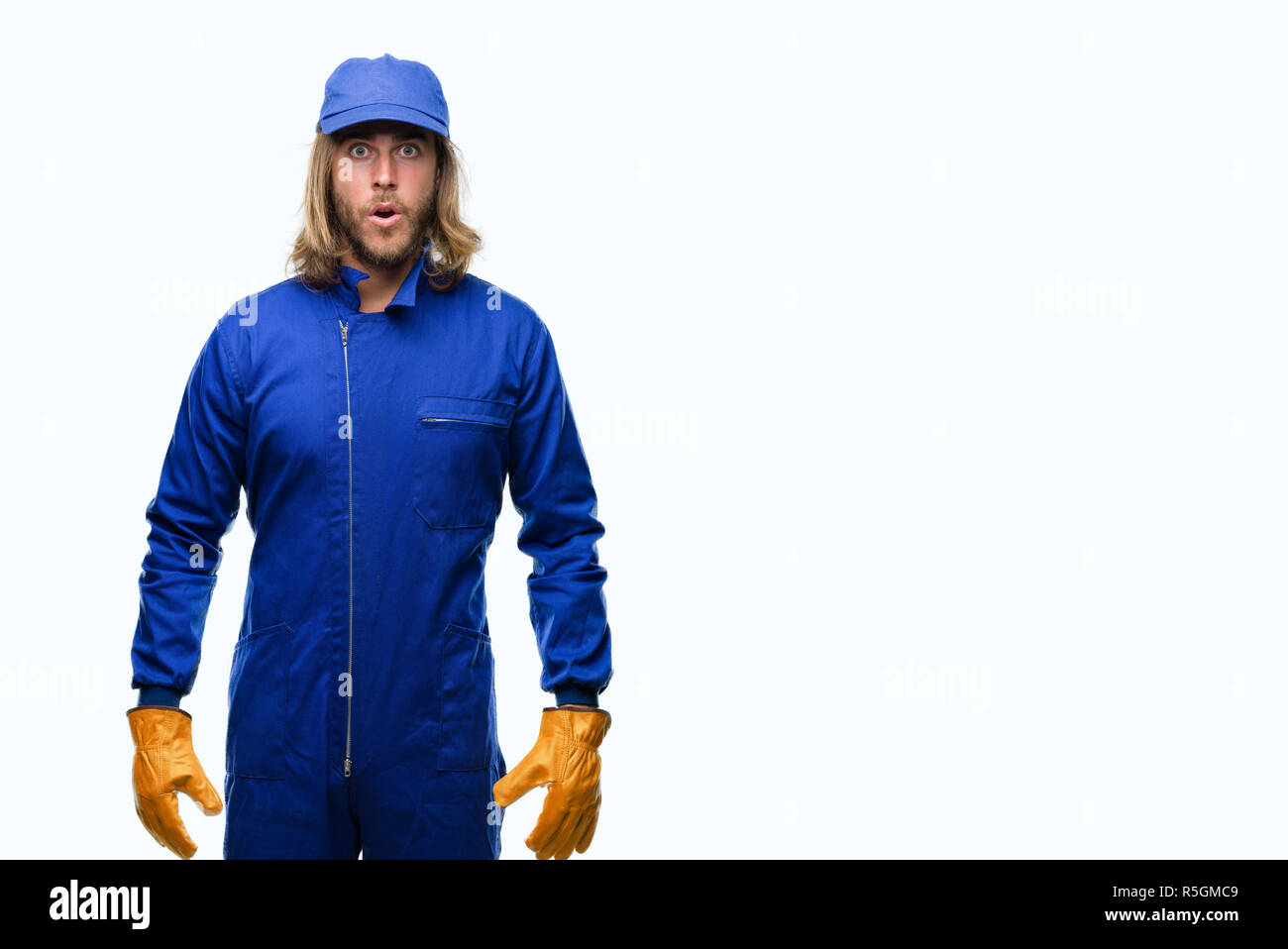 Young Handsome Mechanic Man With Long Hair Over Isolated