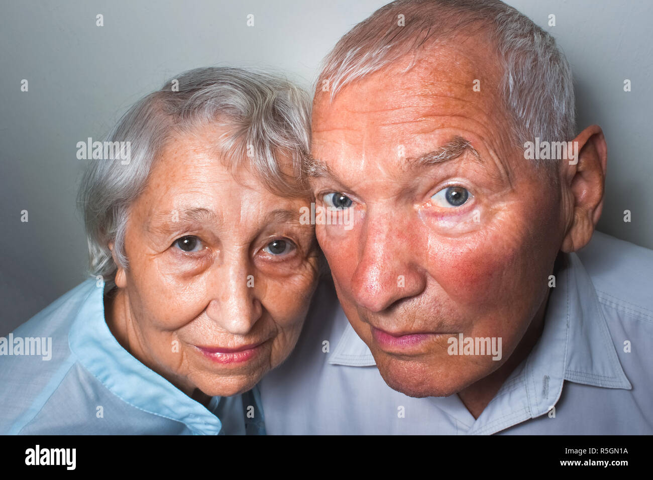 The elderly couple on studio background Stock Photo