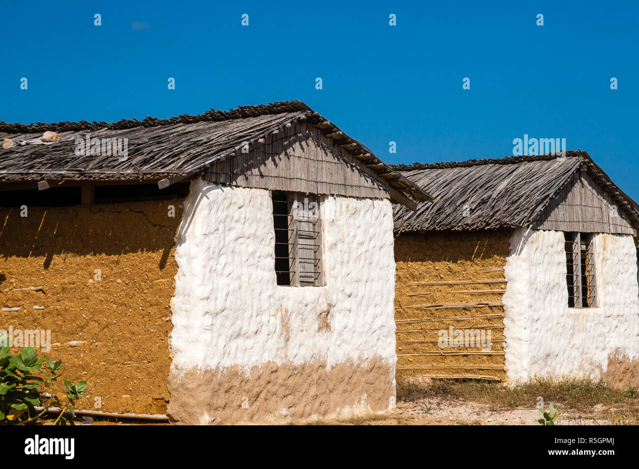 Traditional adobe house next to the sea under blue sky Stock Photo