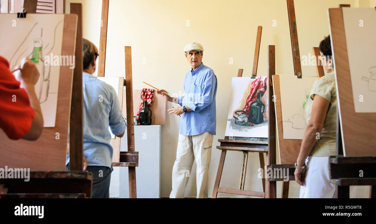 Teacher At Work In Painting Class With Senior Students Stock Photo - Alamy