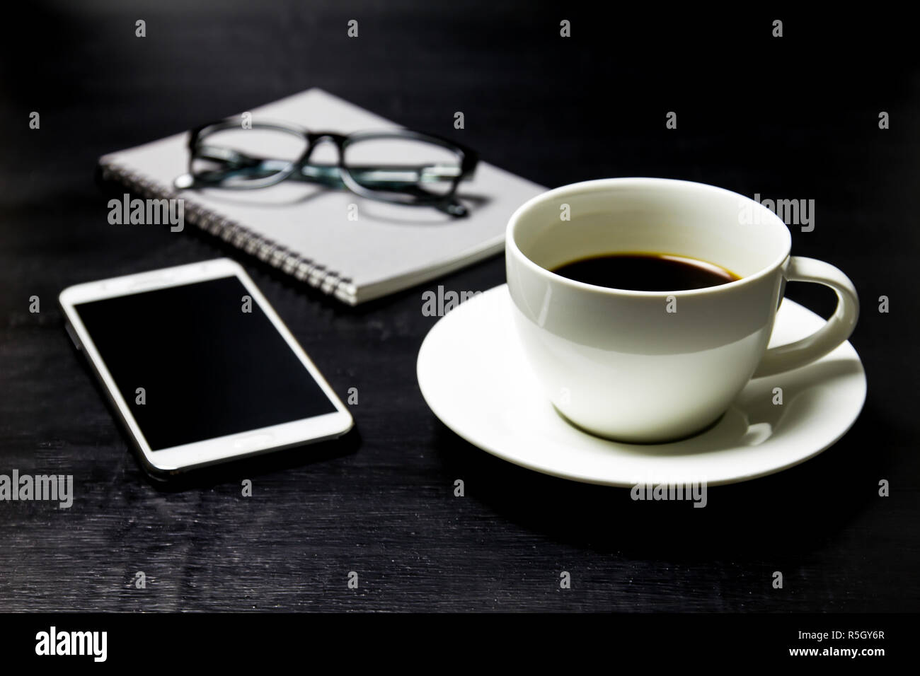 Coffee with notebook ,glasses and mobile phone on wood background Stock ...