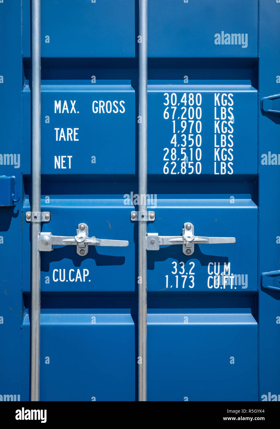 Blue industrial shipping container door with weights specifications Stock Photo