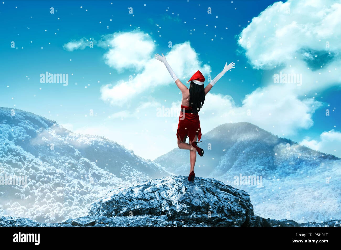 Asian woman wearing santa claus costume standing on the top of mountain ...