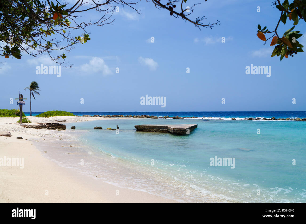 Hidden beach with white sand and blue water in Curacao Stock Photo