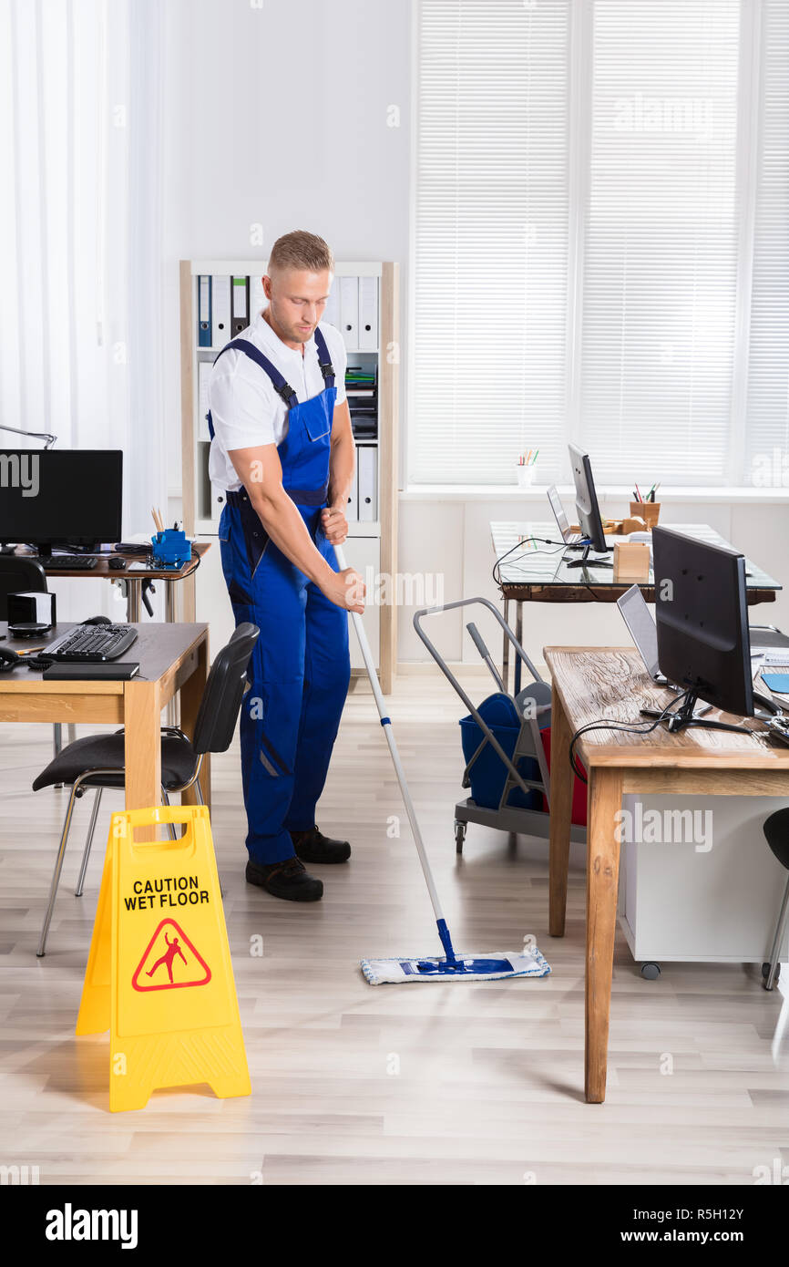 Male Janitor Cleaning Floor With Mop Stock Photo Alamy