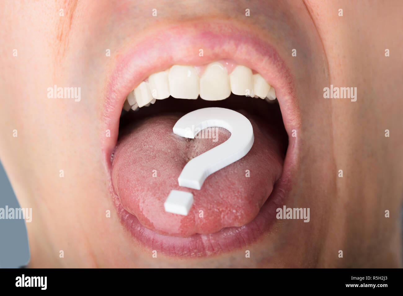 Question Mark On Man's Tongue Stock Photo