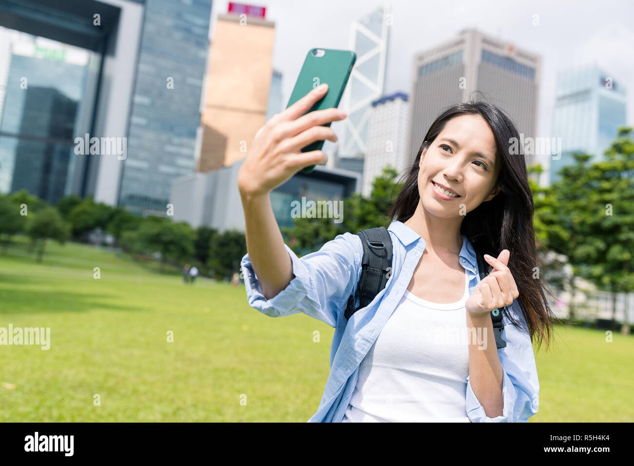 Woman taking selfie with korean love gesture in Hong kong city Stock ...
