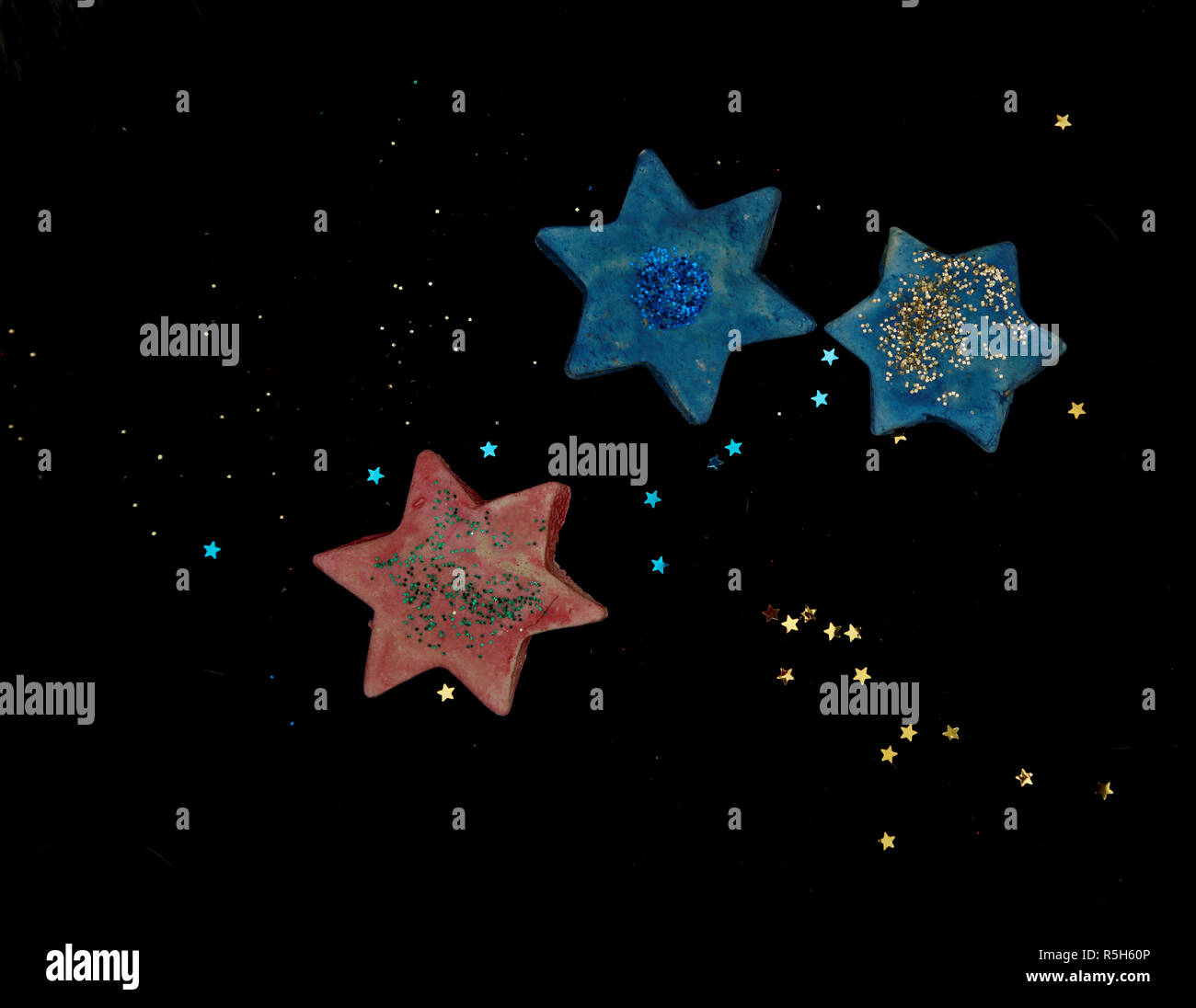 Blue and red ceramic and plastic stars with black background Stock Photo