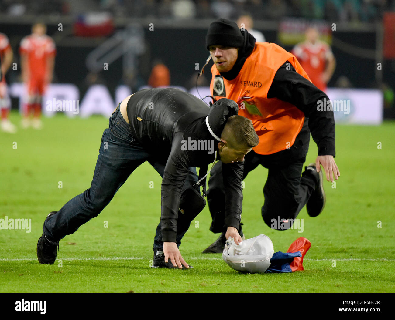 Leipzig, Germany - November 15, 2018. A Russia fan is chased by a steward after running onto the pitch during international friendly Germany vs Russia Stock Photo