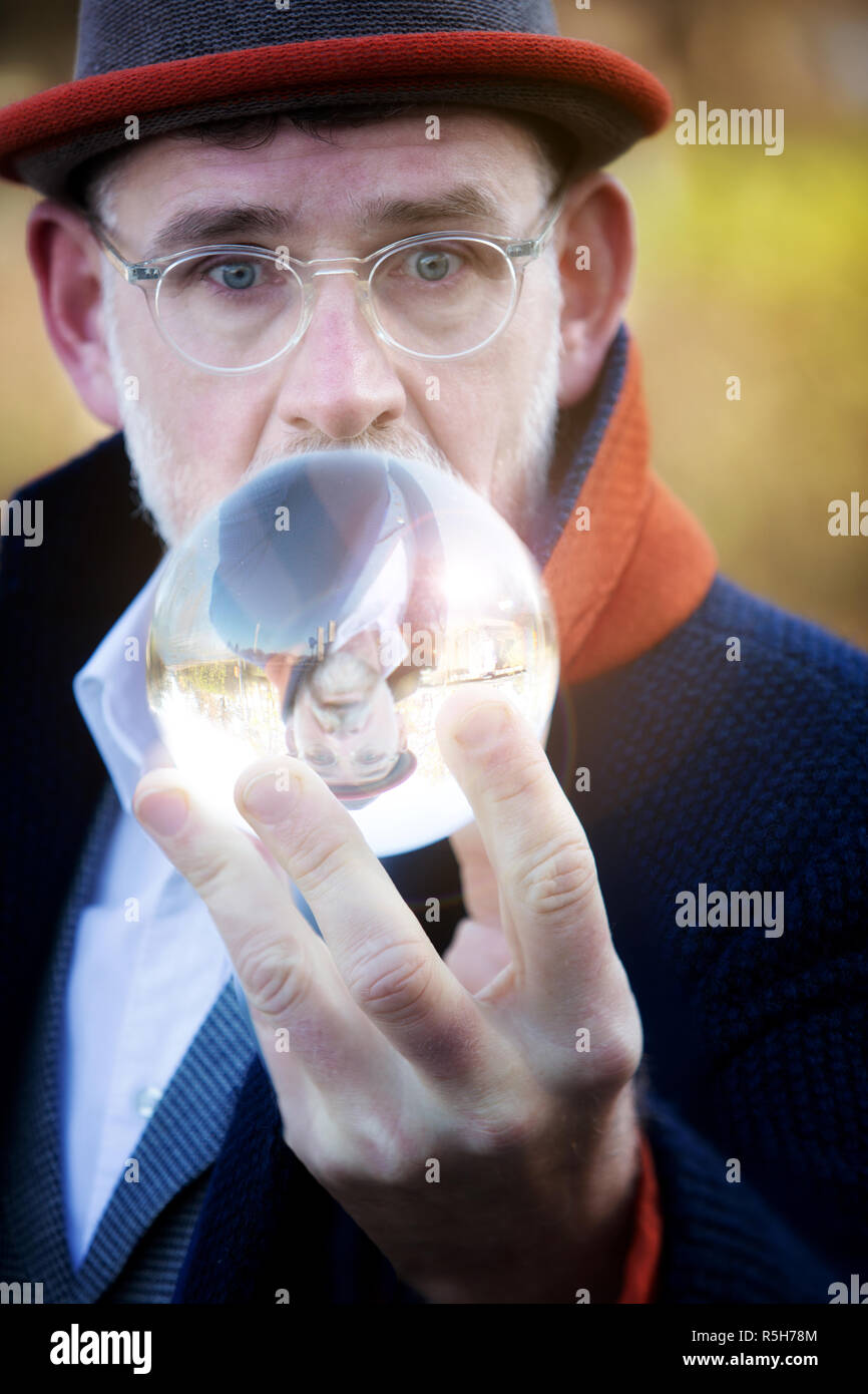Businessman looking into crystal ball hi-res stock photography and ...