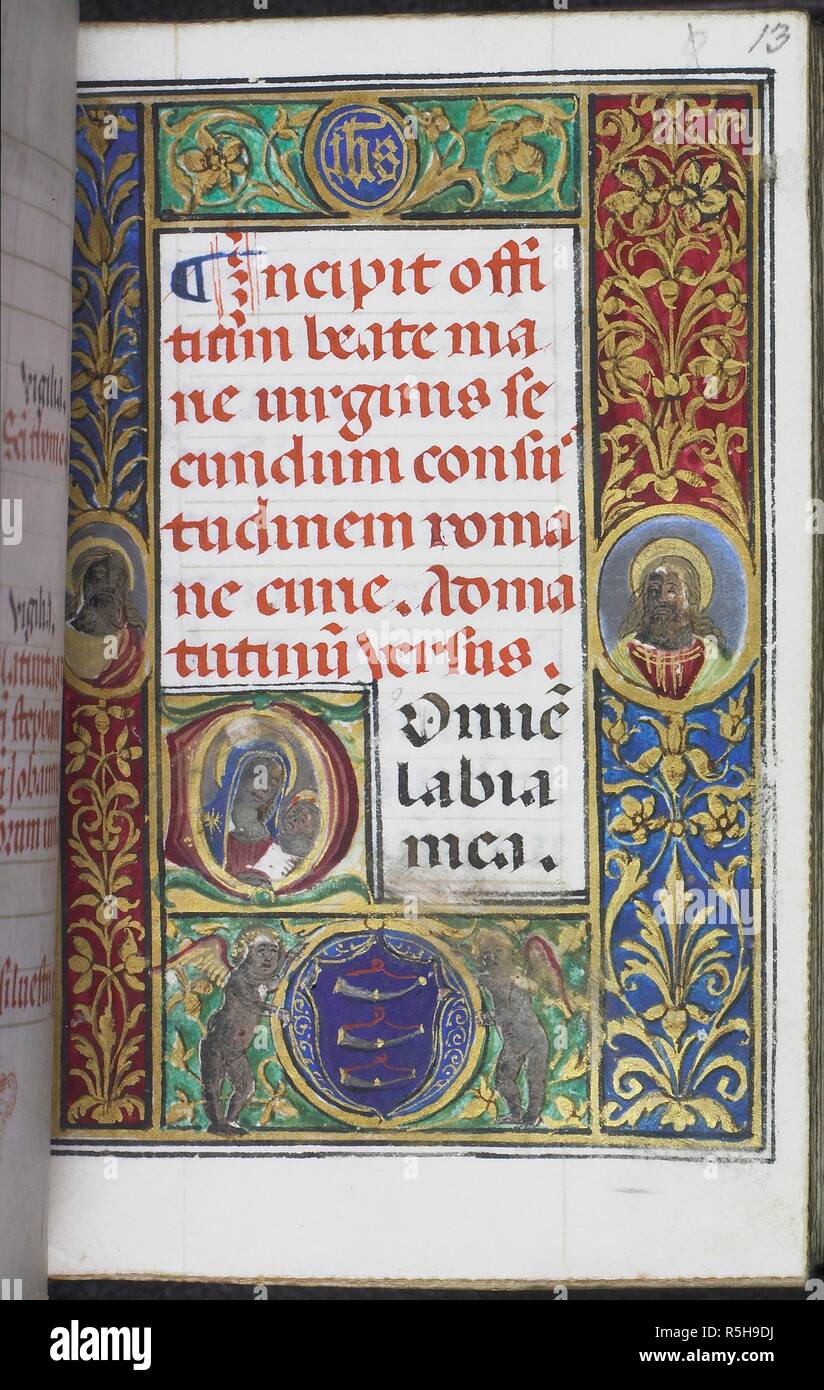 Historiated initial 'D' (ominus)' with Virgin and Child at the beginning of Matins in the Hours of the Virgin, with full paneled border of gold foliate decoration on coloured ground. In the borders, medallions with heads of haloed saints, 'IHS' monogram and coat of arms of the Guicciardini family of Florence (three hunting horns on azur) held by putti. Book of Hours, Use of Rome. Italy, Central (Florence); last quarter of the 15th century. Source: Harley 2857, f.13. Language: Latin. Stock Photo