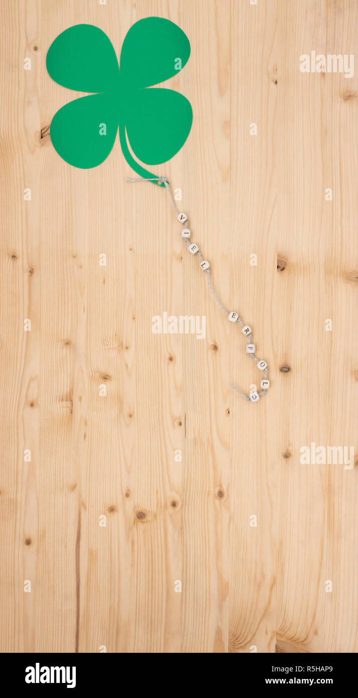 The Words Good Luck And A Shamrock On A Drawstring On Wood Stock