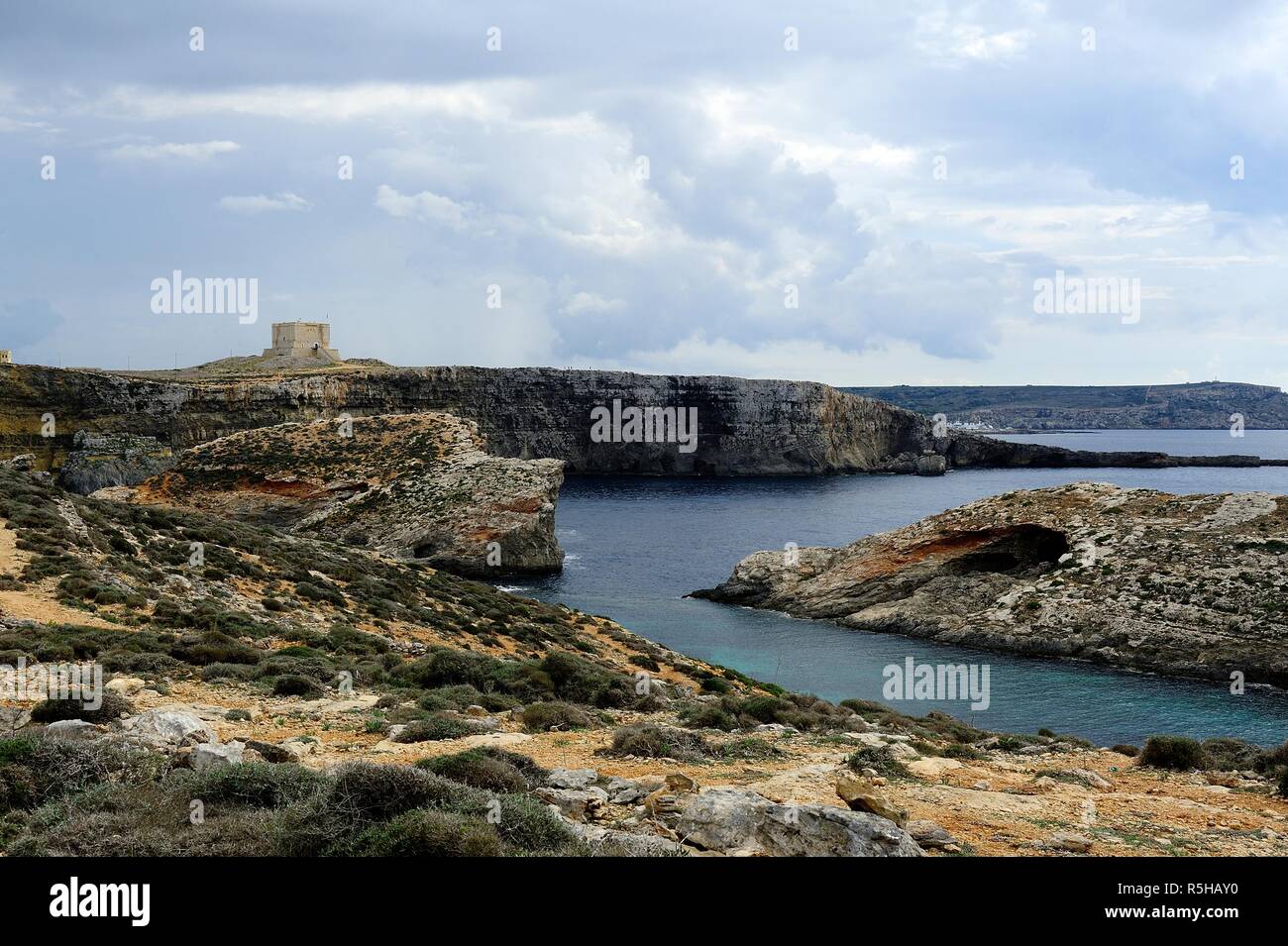 Coimino, Malta - 12th October 2018:Visitors expoloring the cliffs of Comino and St Marys watch Tower Stock Photo