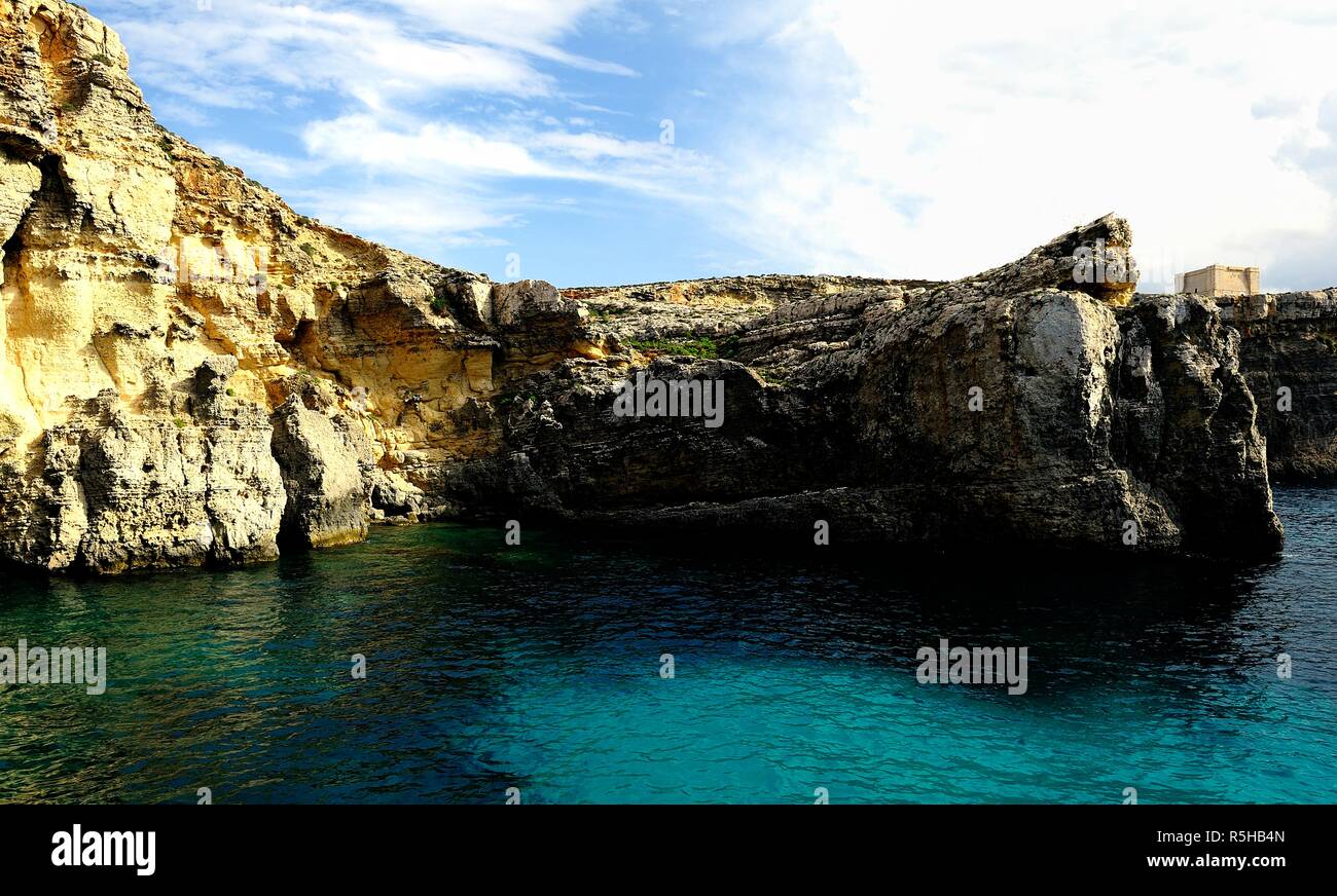 The cliffs of Comino and St Marys watch Tower Stock Photo