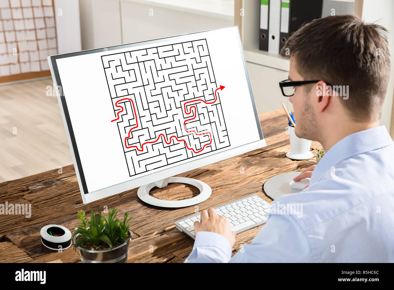 Businessman Solving Maze On Computer Stock Photo - Alamy