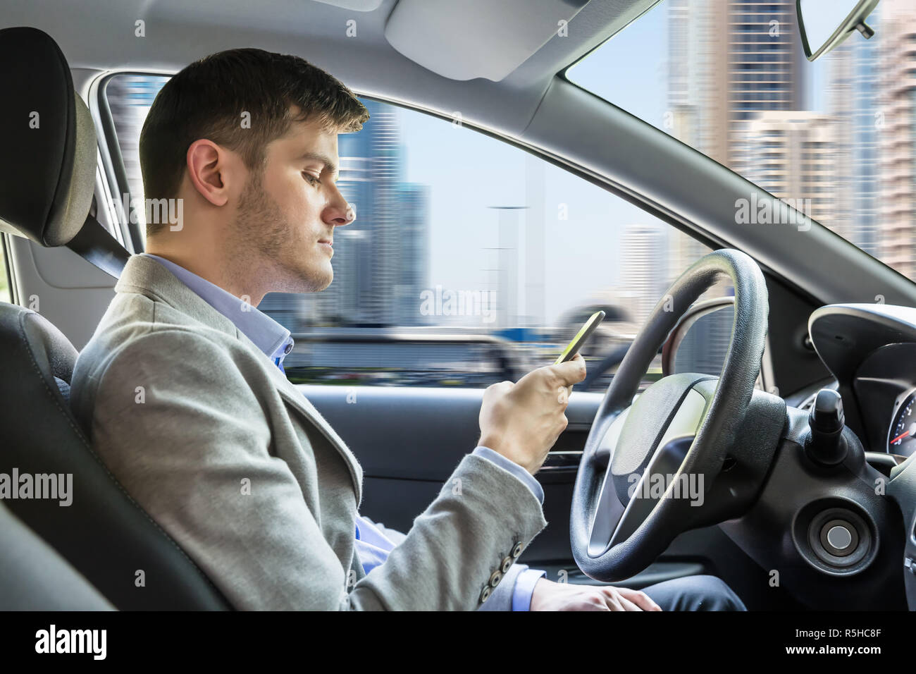 Man Sitting Inside Car Using Mobile Phone Stock Photo - Alamy