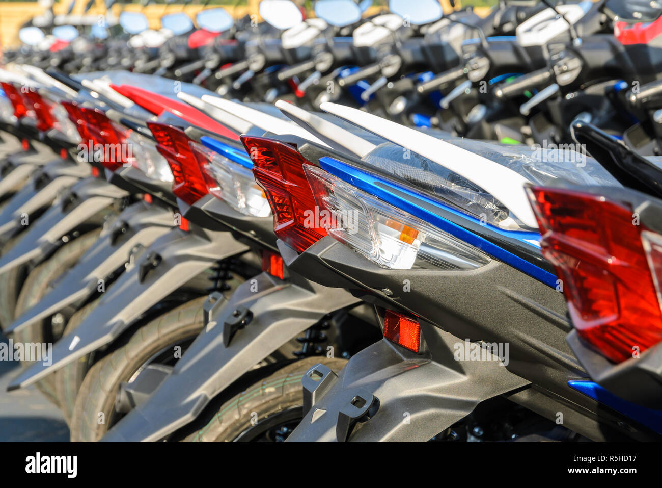 New motorcycles parked in a row on the sidewalk, transportation background  Stock Photo - Alamy