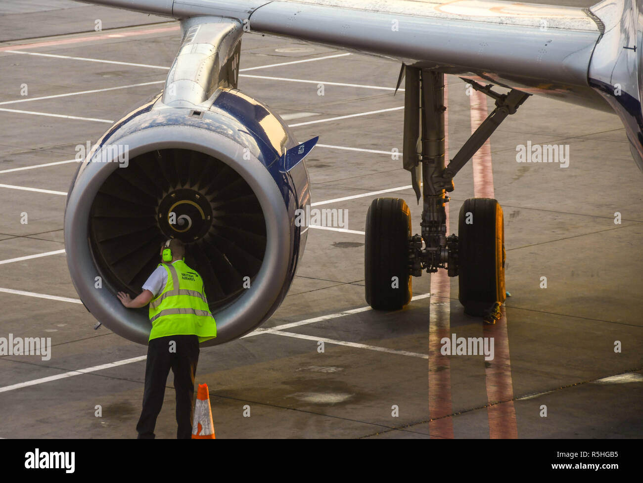 Pilot of a British Airways Airbus jet doing a walk-around check and inspection before a flight. Stock Photo