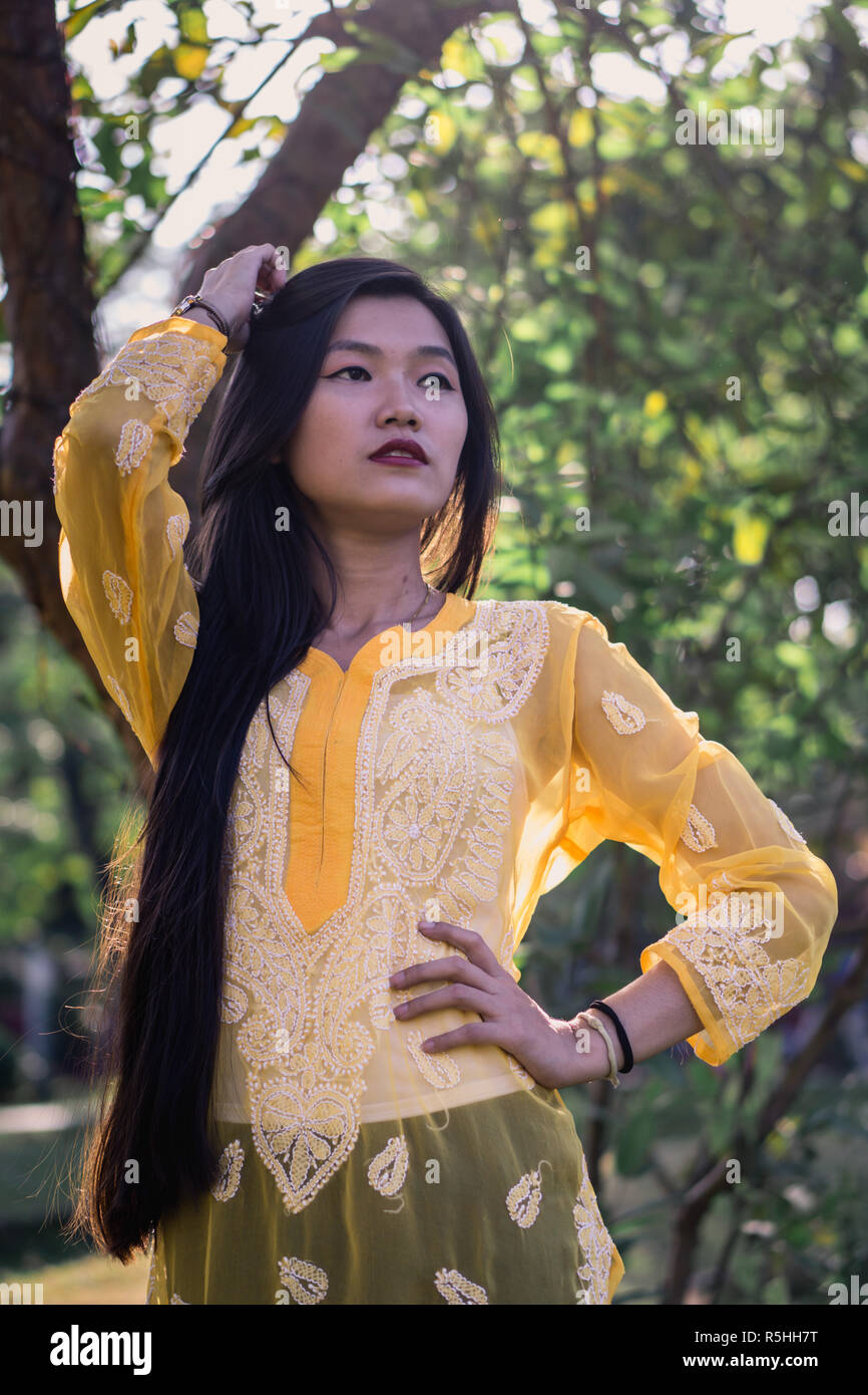 Girl in Chikankari Kurti by Zahba posing for the camera in a park. Stock Photo