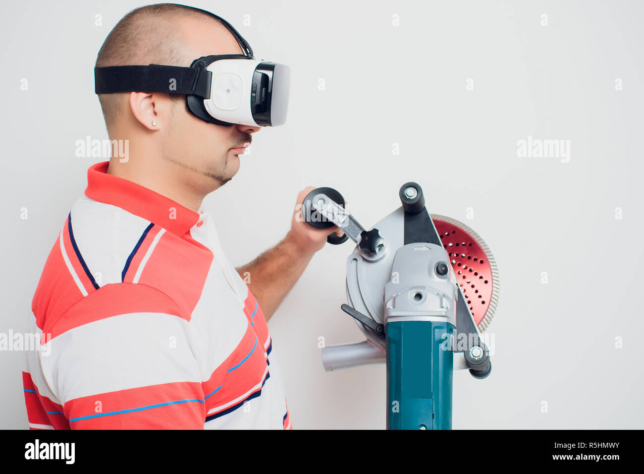 Construction worker with a puncher scream on a white background Stock Photo