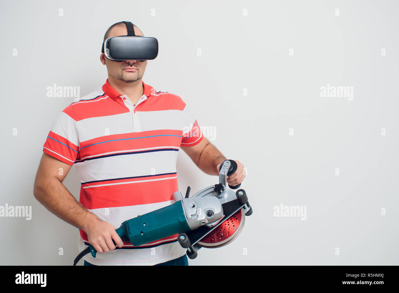 Construction worker with a puncher scream on a white background Stock Photo