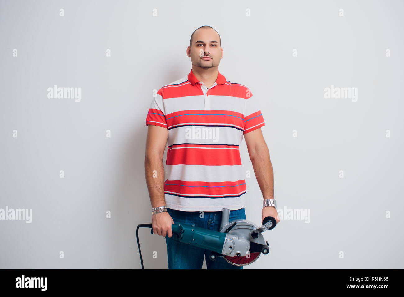 Construction worker with a puncher scream on a white background Stock Photo