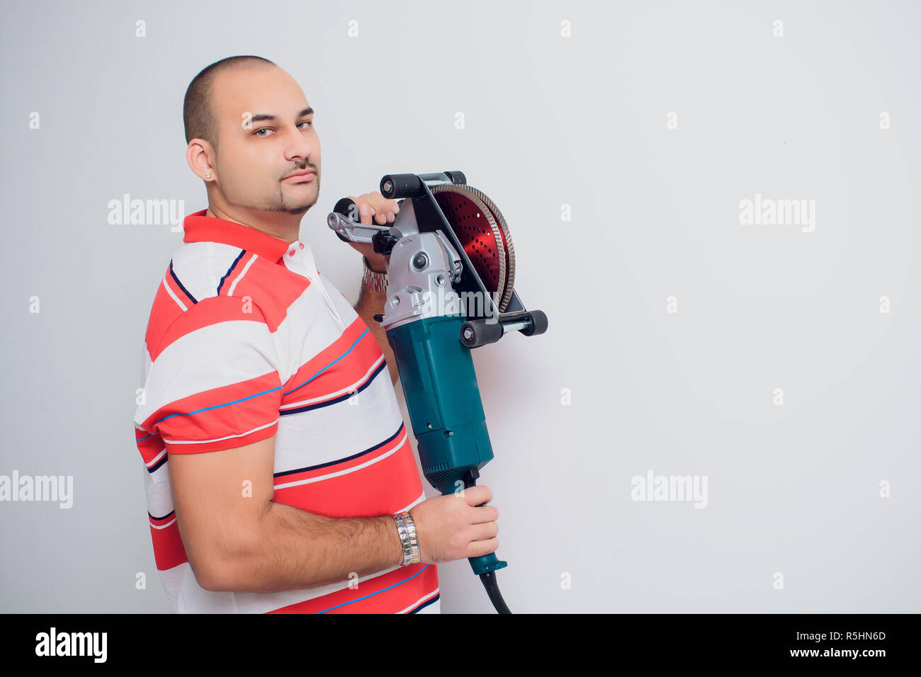 Construction worker with a puncher scream on a white background Stock Photo
