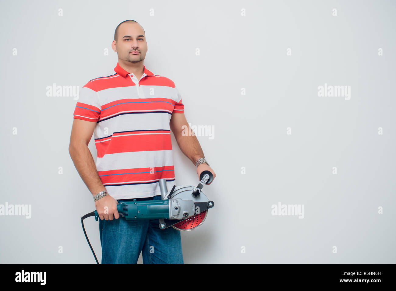 Construction worker with a puncher scream on a white background Stock Photo
