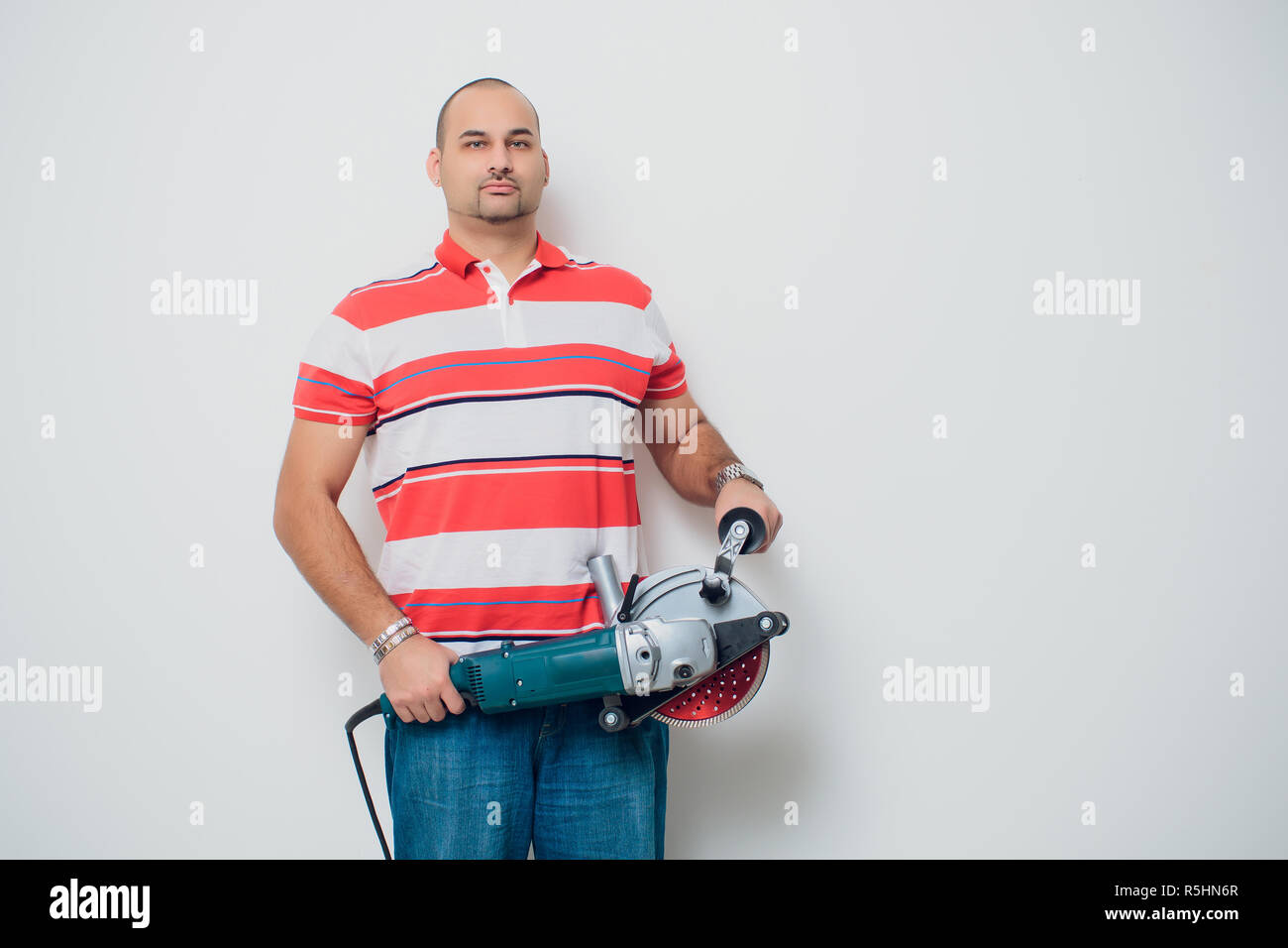 Construction worker with a puncher scream on a white background Stock Photo