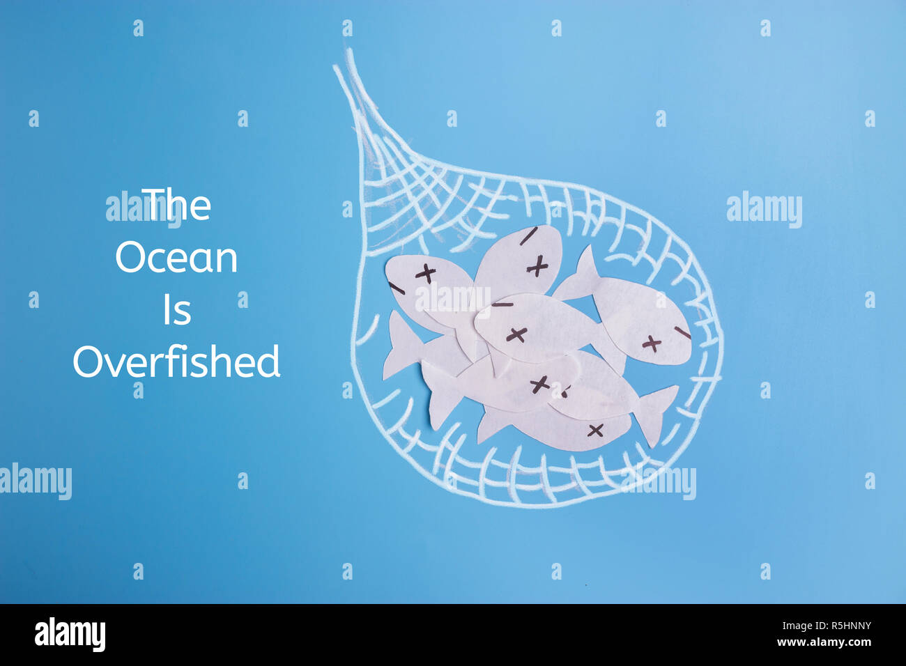 ocean is overfished concept image. paper fish and toy ship Stock Photo ...