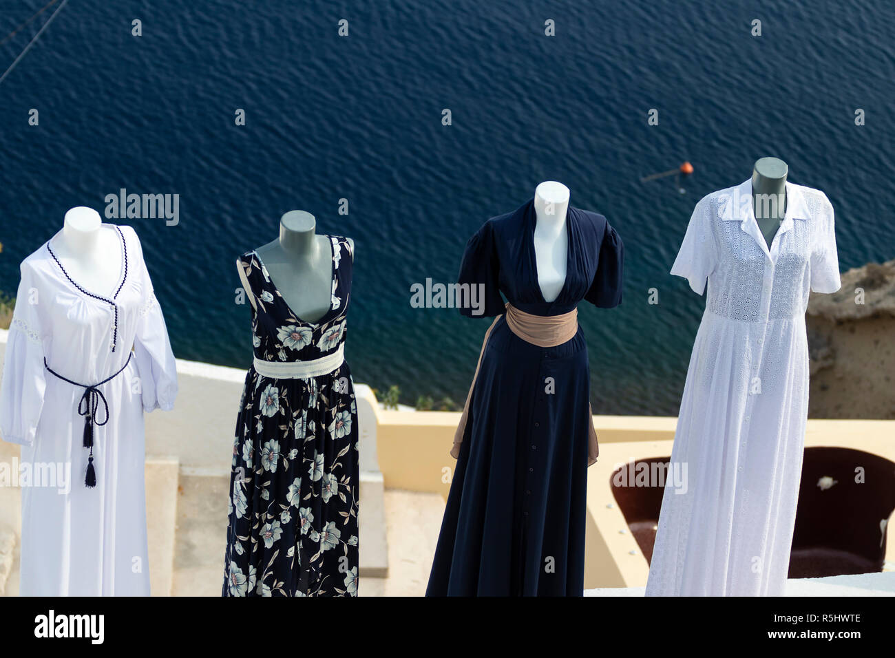 Luxury dresses in a fashion store high above the sea in Oia, Santorini, Greece. Stock Photo