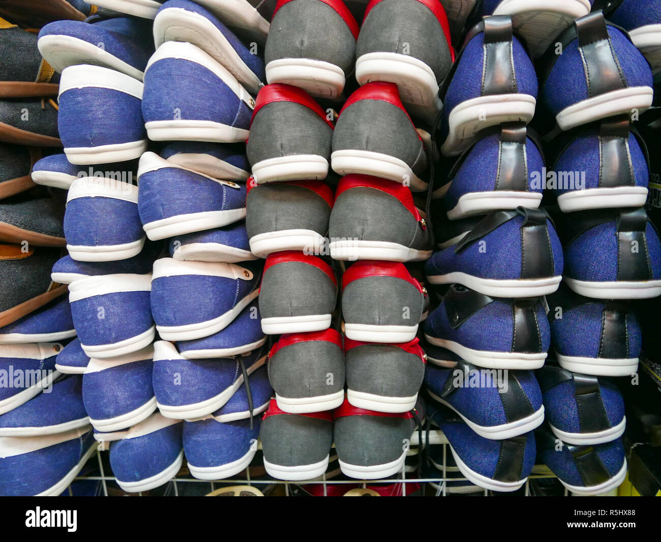 Sport shoes in rows and columns on the rack. Shoe texture close up ...