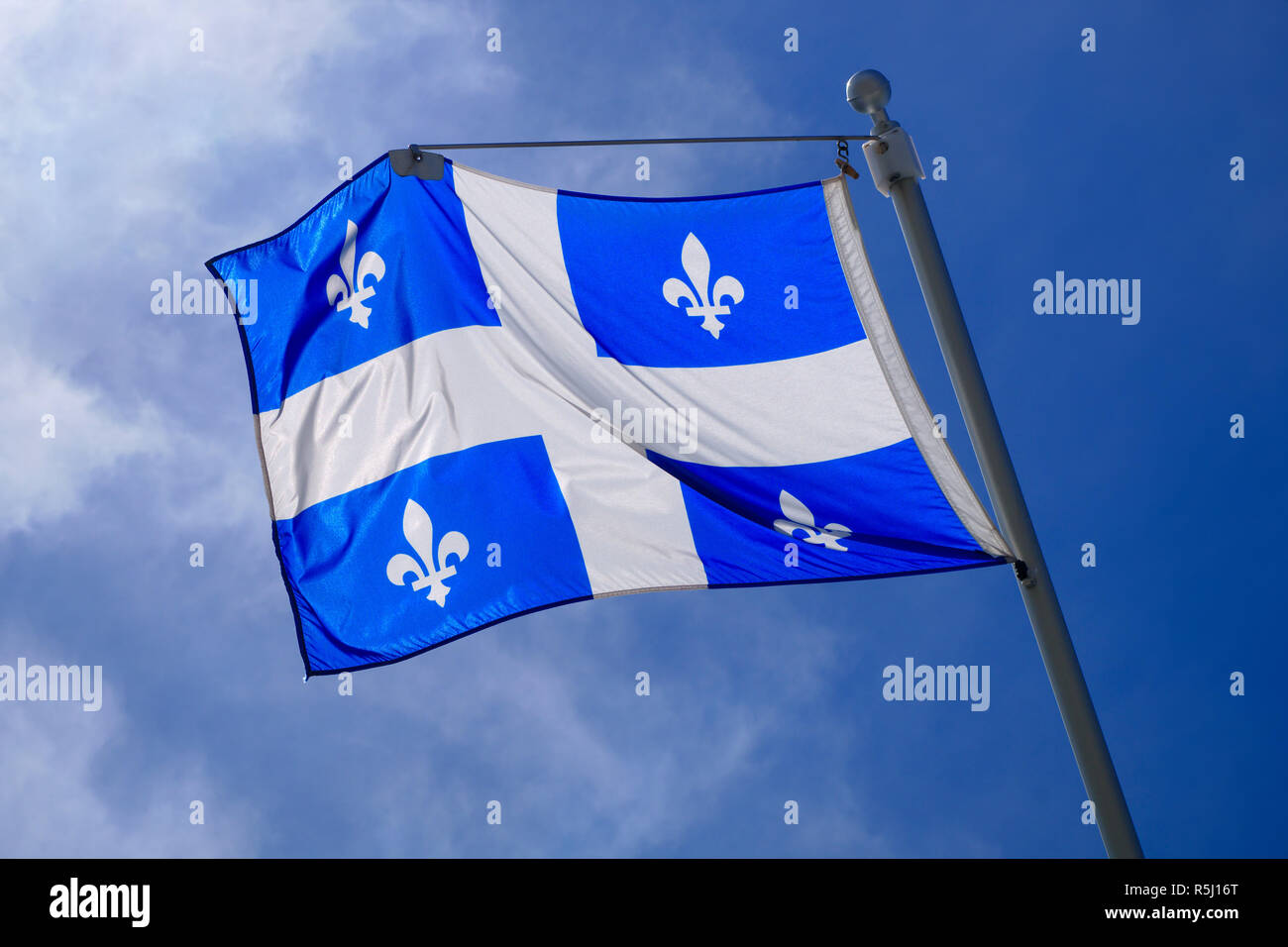 Quebec Flag pole on blue sky national st-jean banner Stock Photo