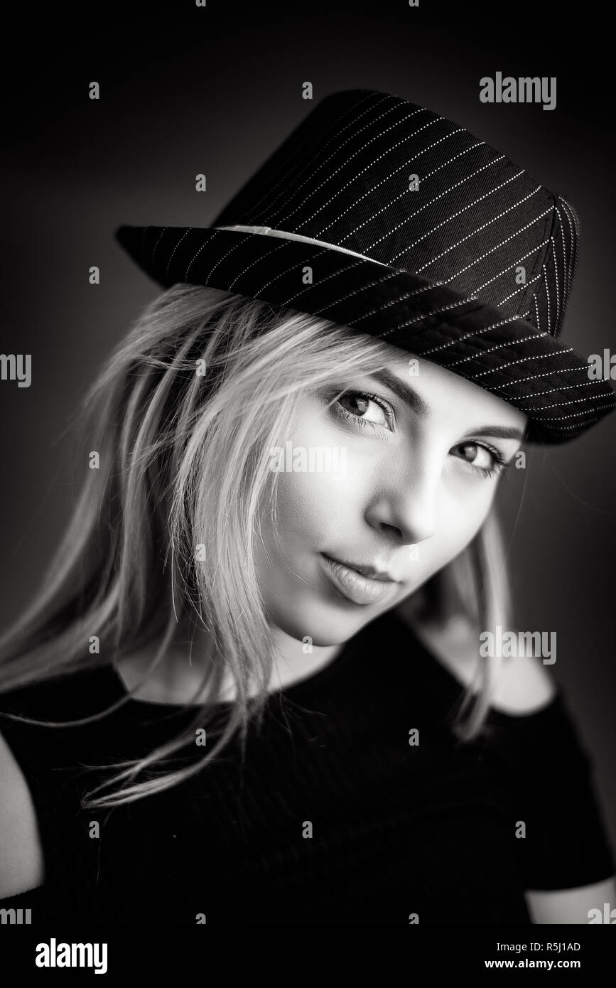 Studio Portrait of a young blonde woman wearing a black hat Stock Photo ...